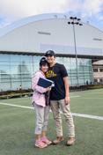 A mother and son stand on the practice 场 of the ASUI-Kibbie Activity Center.